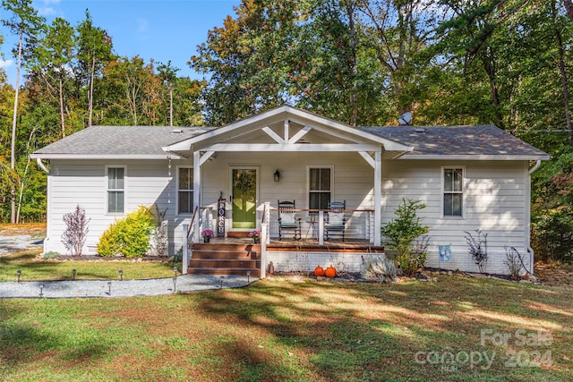 view of front of house with a porch and a front lawn