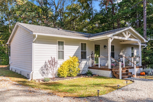 view of front of home with covered porch and a front yard