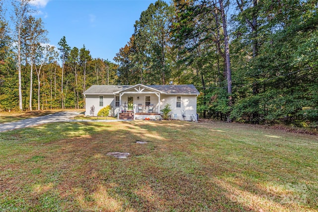 ranch-style house featuring a front yard and covered porch