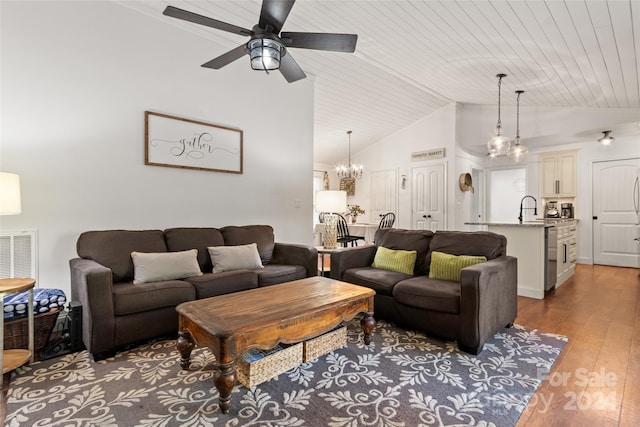 living room featuring wood ceiling, hardwood / wood-style flooring, high vaulted ceiling, ceiling fan with notable chandelier, and sink