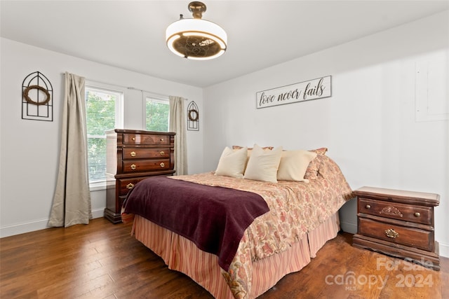 bedroom with dark hardwood / wood-style flooring