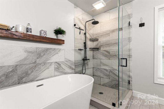 bathroom with shower with separate bathtub