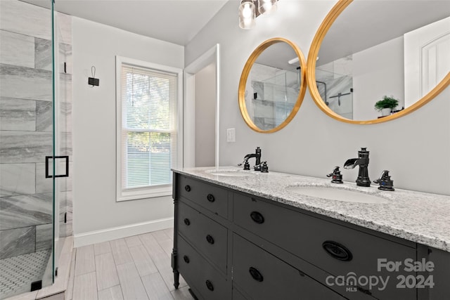 bathroom with vanity and a shower with shower door