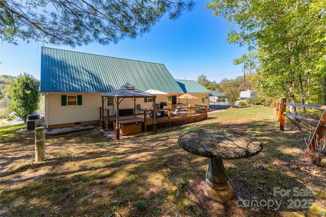 exterior space with a gazebo, a deck, a hot tub, and cooling unit