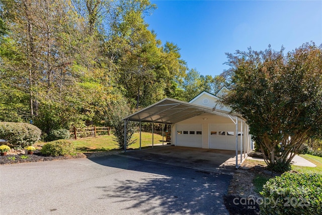 exterior space with a garage and a carport