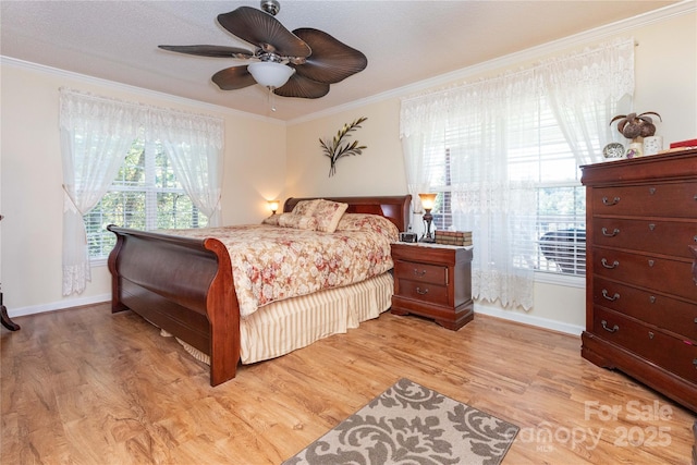 bedroom with wood-type flooring, ceiling fan, and crown molding