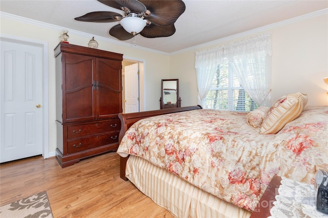 bedroom with ornamental molding, light wood-type flooring, and ceiling fan