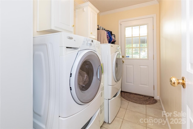 washroom with ornamental molding, light tile patterned floors, cabinets, and independent washer and dryer