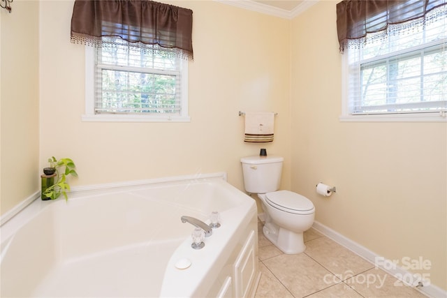 bathroom featuring toilet, tile patterned floors, ornamental molding, and a bathing tub