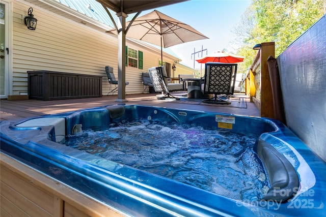 view of swimming pool with a hot tub and a deck