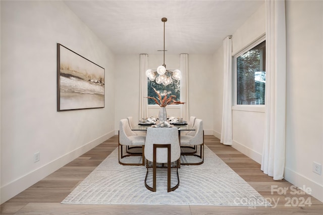 dining area featuring a chandelier and light hardwood / wood-style flooring