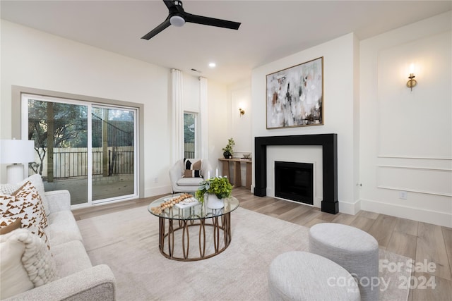 living room with ceiling fan and light wood-type flooring