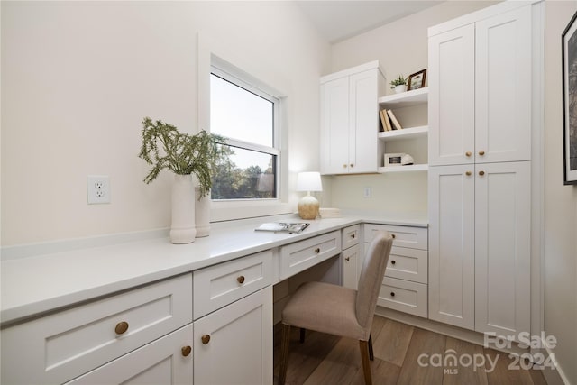 office area with built in desk and hardwood / wood-style flooring