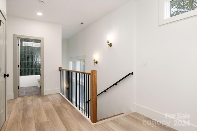 stairs with hardwood / wood-style flooring