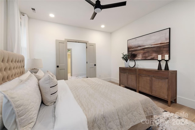 bedroom featuring ceiling fan and light hardwood / wood-style flooring