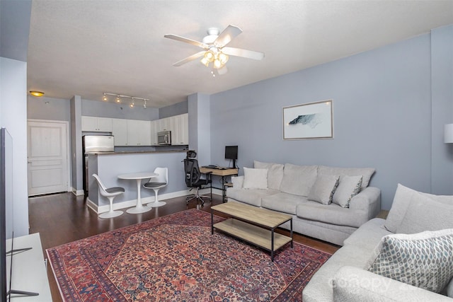 living room featuring dark hardwood / wood-style floors and ceiling fan