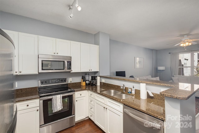 kitchen featuring kitchen peninsula, white cabinets, and stainless steel appliances