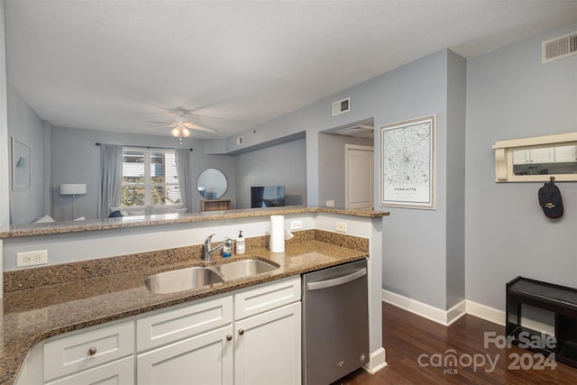 kitchen featuring dishwasher, white cabinetry, and dark stone countertops