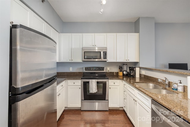 kitchen featuring sink, appliances with stainless steel finishes, dark hardwood / wood-style floors, and white cabinets