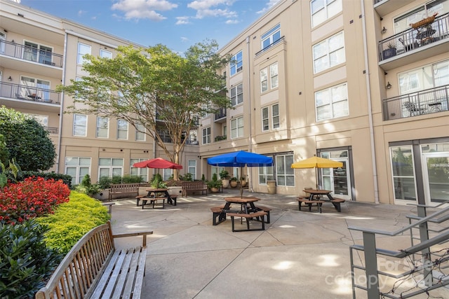 view of home's community with a patio area and an outdoor fire pit