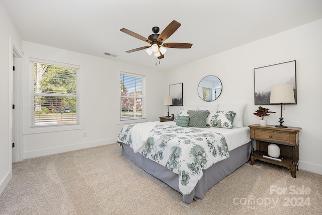 bedroom with light carpet and ceiling fan