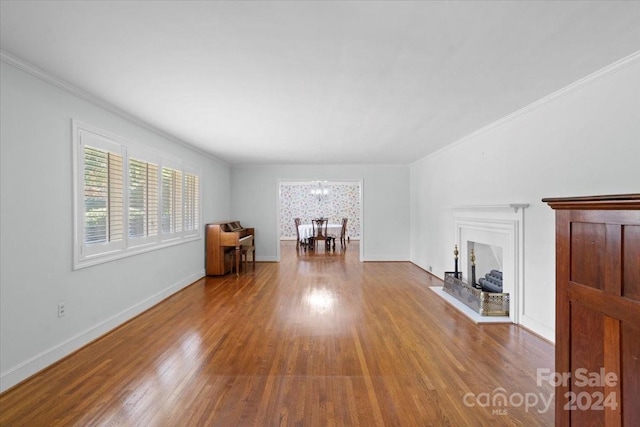 unfurnished living room featuring ornamental molding and hardwood / wood-style floors