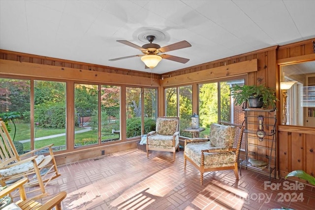 unfurnished sunroom with ceiling fan and a wealth of natural light