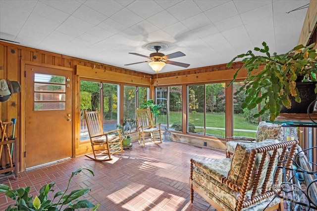 sunroom featuring ceiling fan