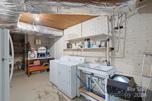 clothes washing area featuring independent washer and dryer and wooden ceiling