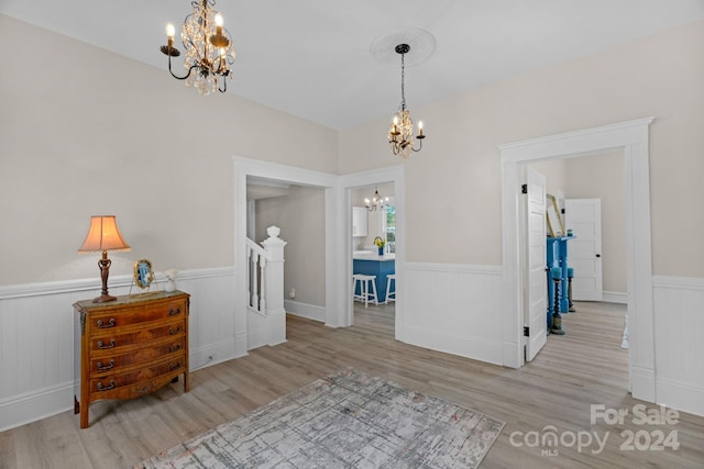 interior space featuring light hardwood / wood-style flooring and an inviting chandelier