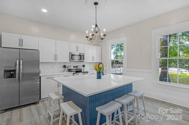 kitchen featuring white cabinetry, stainless steel appliances, a wealth of natural light, and sink