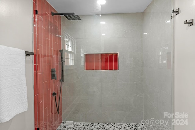 bathroom with a tile shower