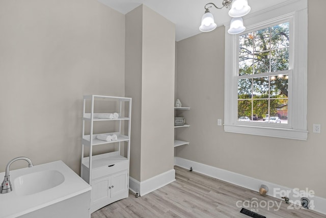 bathroom featuring vanity, an inviting chandelier, and hardwood / wood-style flooring