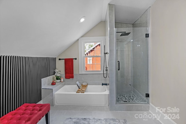 bathroom with lofted ceiling and separate shower and tub