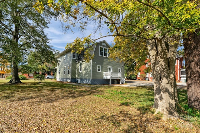 view of side of home featuring a lawn