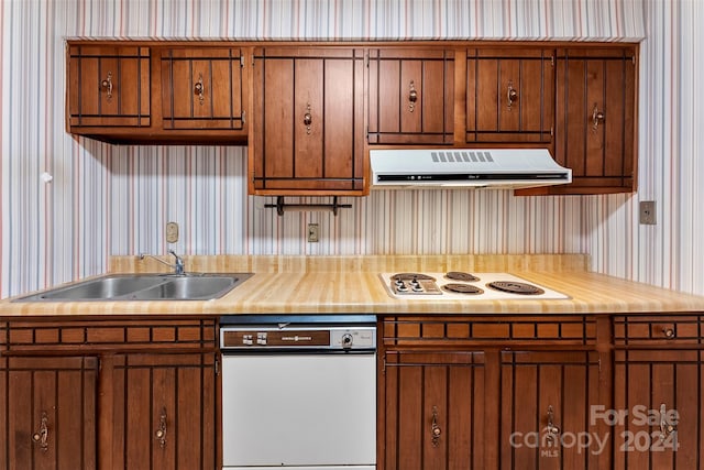 kitchen featuring white appliances and sink