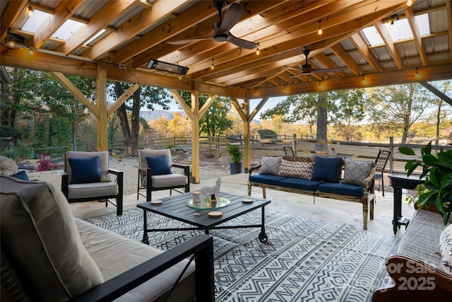 view of patio / terrace featuring a gazebo, ceiling fan, and an outdoor living space