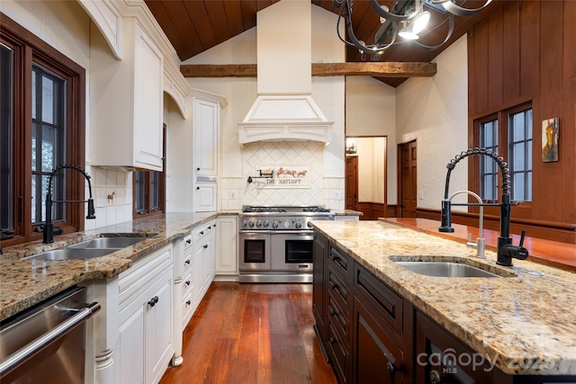 kitchen with appliances with stainless steel finishes, sink, and white cabinets