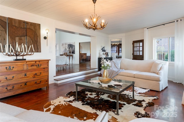 living room with an inviting chandelier and dark hardwood / wood-style floors