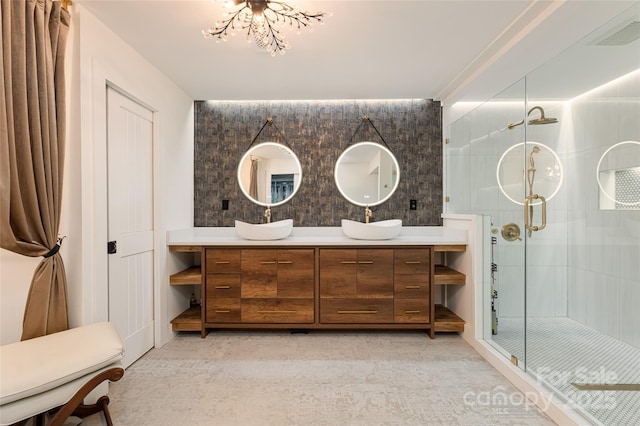 bathroom featuring a shower with door, vanity, and an inviting chandelier