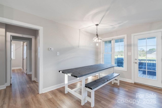 dining area featuring baseboards and wood finished floors