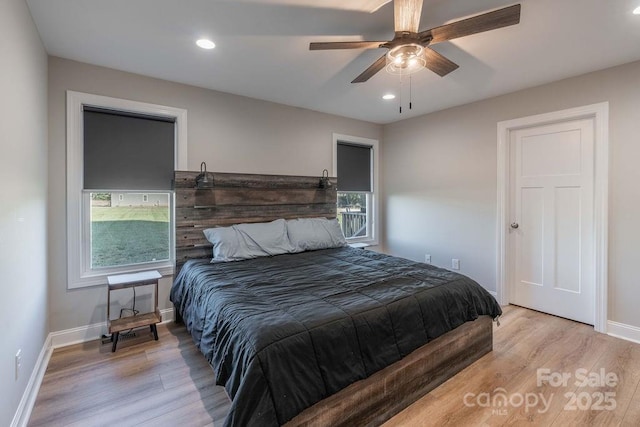 bedroom with baseboards, ceiling fan, light wood-type flooring, and recessed lighting