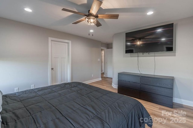 unfurnished bedroom featuring baseboards, ceiling fan, wood finished floors, and recessed lighting