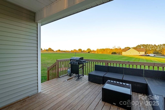 wooden terrace featuring a yard, grilling area, and an outdoor hangout area