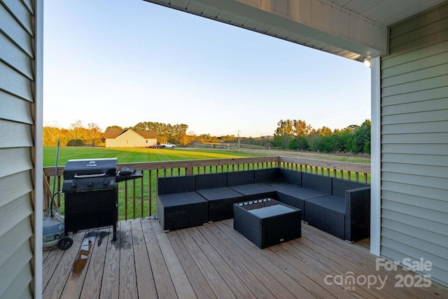 deck featuring outdoor lounge area, a lawn, and area for grilling