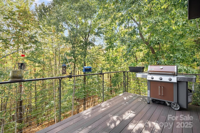 wooden terrace with a grill