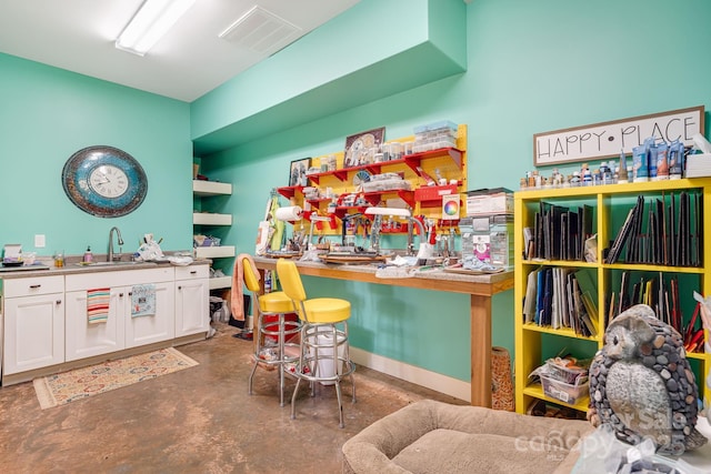 recreation room with concrete flooring and wet bar