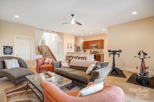 living room with baseboards, stairway, a ceiling fan, and recessed lighting