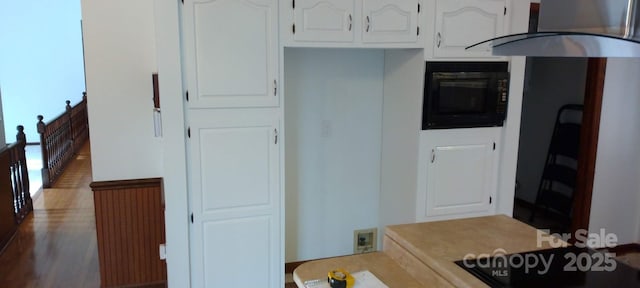 kitchen with white cabinetry and exhaust hood