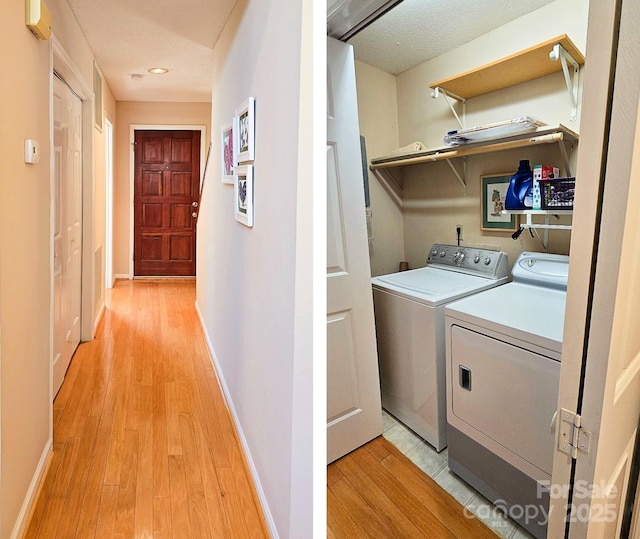 laundry room with washing machine and dryer, laundry area, baseboards, and light wood finished floors